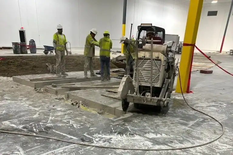Construction workers pouring concrete at Southwest ADI project site.