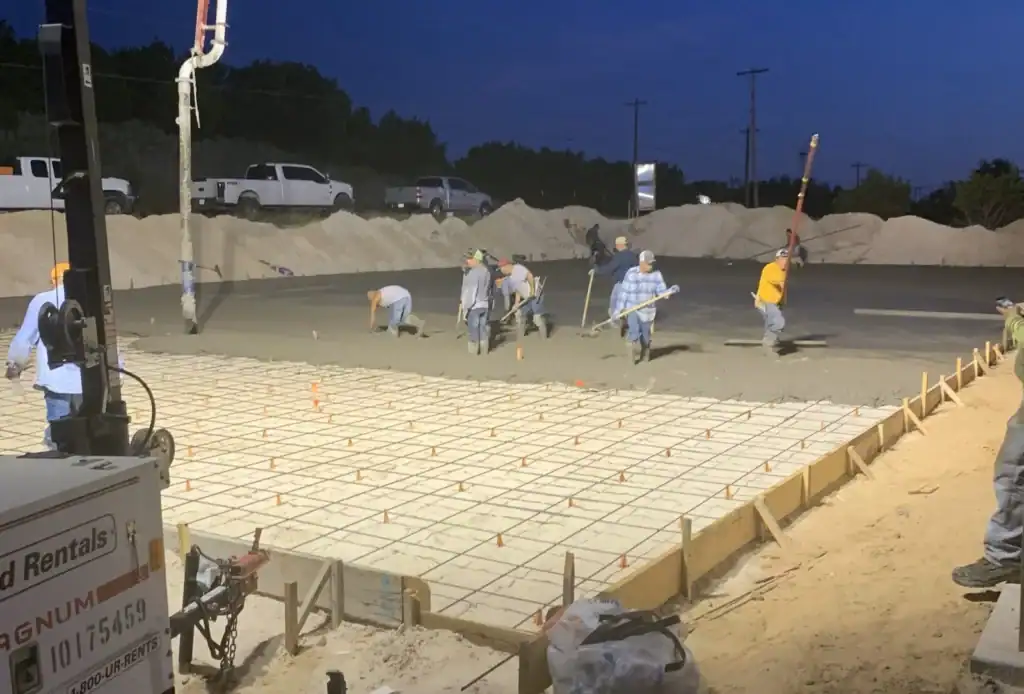 Titan Ready Mix Plant construction site with workers pouring concrete.