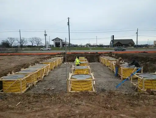 Construction workers preparing foundation at Murphy USA site.